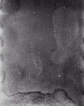 Blank grained film strip texture background with heavy grain, dust and light leak. Old expired soviet moldy photographic film scan. Black and white.