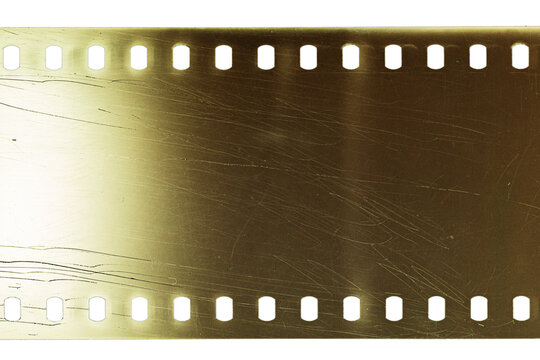 Dusty and grungy 35mm film texture or surface. Perforated scratched camera film isolated on white background.