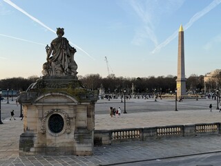 Fototapeta premium Place de la Concorde in Paris, France, at sunset with the Egyptian obelisk and statue of Marianne in the foreground.