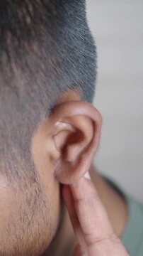 Listening to sounds with a hand on the ear