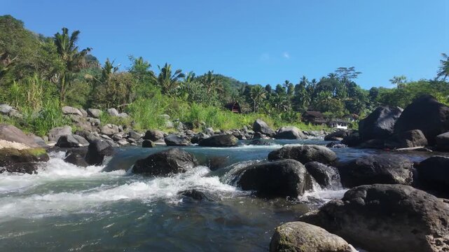 Beautiful river flowing through Sideman, Bali. Slow motion tracking forward shot of sungai telaga waja river in Sideman. Indonesia. 