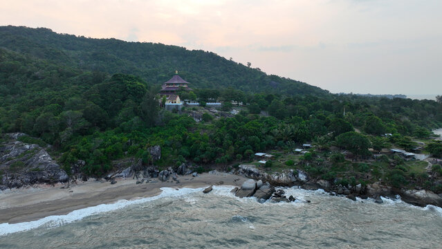 Aerial view of Puri Tri Agung temple on a green hill by the coast of Bangka Island, Indonesia. Breathtaking landscape of Indonesian tourist destinations and cultural heritage