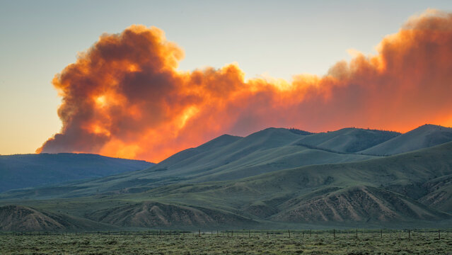 wildfire smoke plume obscuring sunset over mountains - North Park, Colorado