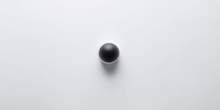 white surface featuring lone trackball pointing device with copy space