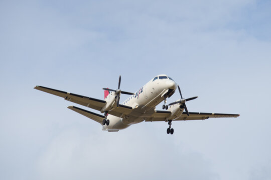 Fukuoka Japan - 2019 02 14: A Japan Air Commuter Saab 340B turboprop in JAL livery on approach to Fukuoka Airport, underside view against a blue sky.
