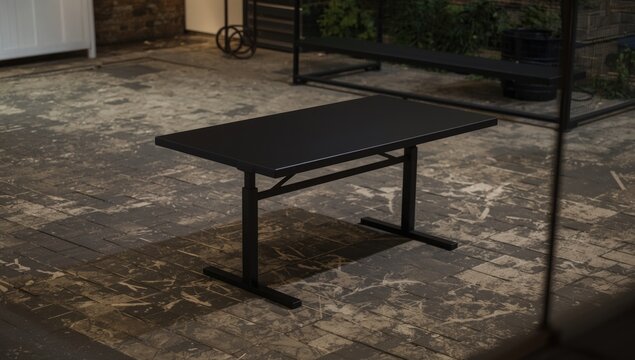 Black modern table on a textured outdoor patio