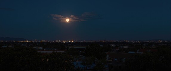 Fototapeta premium Wide perspective of the moon during early night hours