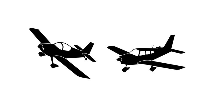 Two black silhouette illustrations of small private general aviation airplanes isolated on white background for travel and aviation themed graphic design.