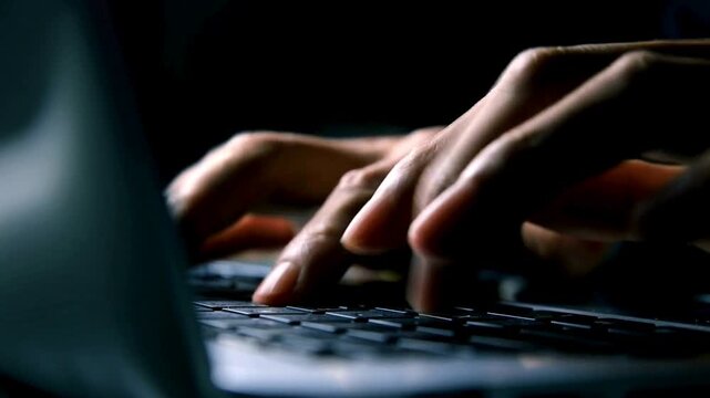 Cybersecurity hacker typing on laptop keyboard in dark room, anonymous programmer coding at night, hands of data thief stealing information