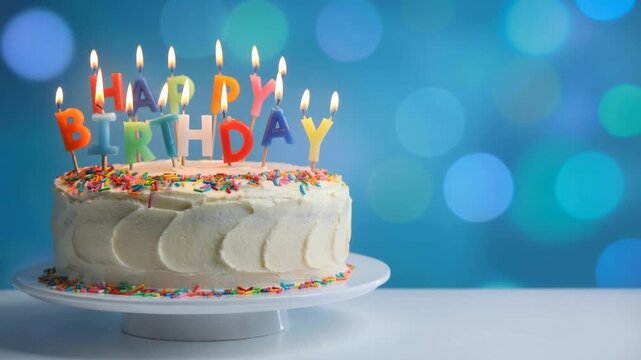 Beautifully decorated birthday cake with colorful sprinkles and glowing lit candles celebration party dessert