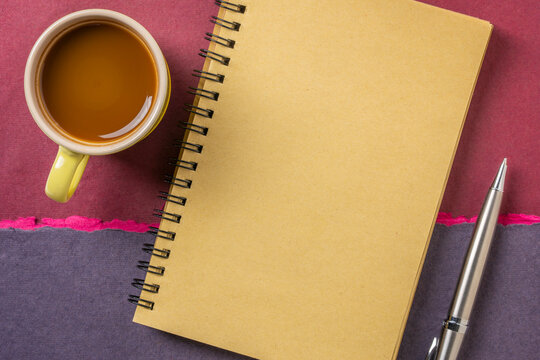 blank spiral notebook, flat lay with coffee on textured art paper