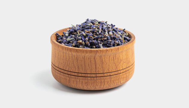 A wooden bowl filled with dried lavender buds sits on a plain white background, showcasing its natural texture and color contrast.