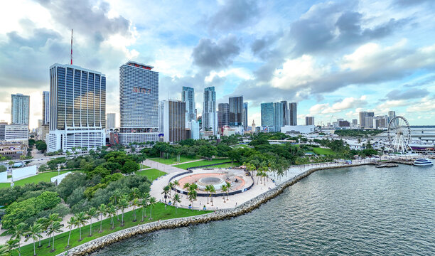 Aerial view of Downtown Miami skyline, Bayfront Park with a circular construction site, and the Ferris wheel along the waterfront in Miami, Florida, United States.
