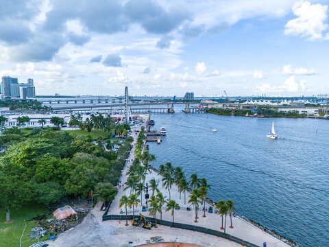 Aerial view of the Downtown Miami skyline, Skyviews Miami ferris wheel, and palm-lined waterfront promenade along Biscayne Bay in Miami, Florida, United States.