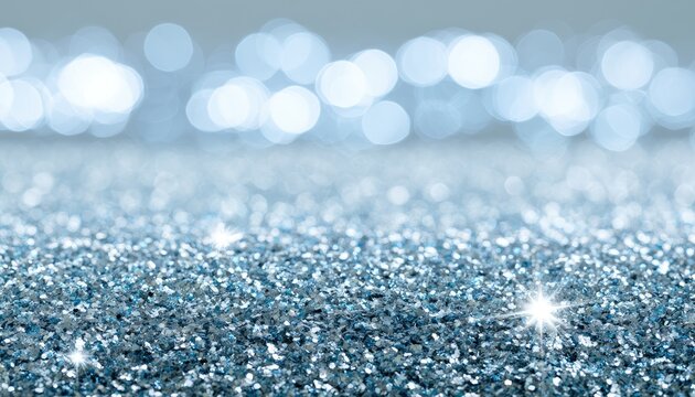 Sparkling silver glitter with soft blue bokeh background