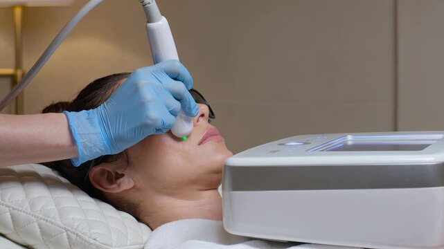 Clinical facial treatment progression showing practitioner scanning face with handheld transducer