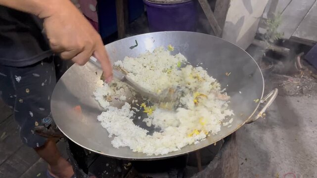 A close-up of the process of cooking traditional Indonesian village fried rice.