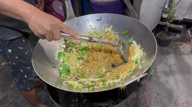 Close up of traditional Indonesian mie goreng cooking process