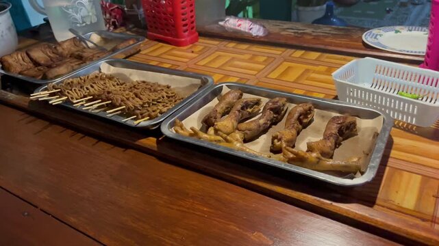 Traditional Javanese angkringan side dishes on aluminum trays