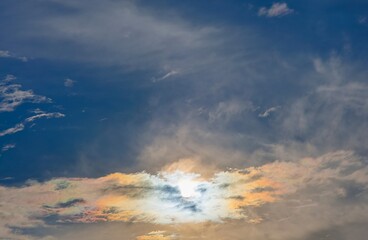 Fototapeta premium Iridescent clouds showing vibrant colors in blue sky