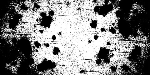 Fototapeta premium Abstract grungy texture with black ink splatters and white distressed background.