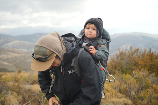 Father and Son Hike on a Mountain Trail in Cloudy Weather