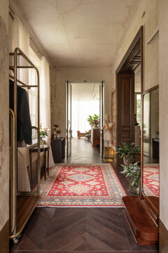 Hallway perspective with rug and reflections