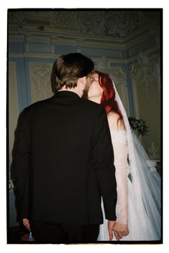 Couple shares a kiss during wedding ceremony
