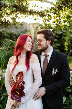 A man and a woman spend time in the garden during a wedding.