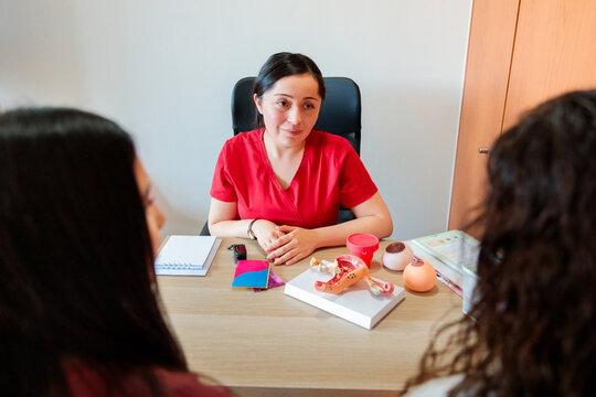 Midwife providing counseling to young patient and family