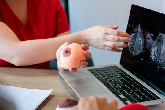 Close-up of midwife demonstrating breast anatomy