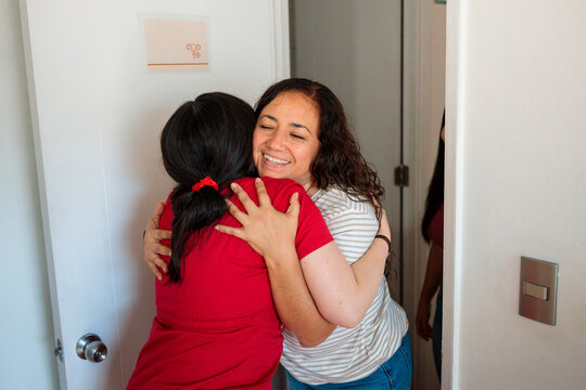 Patient greeting midwife with a hug in clinic