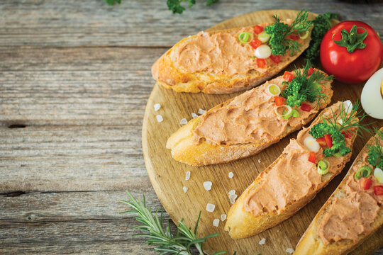 Fresh homemade chicken liver pate on baguette with fresh parsley and spices