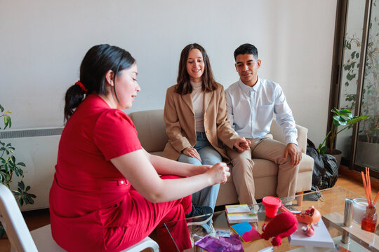 Midwife explaining contraceptive methods to young couple