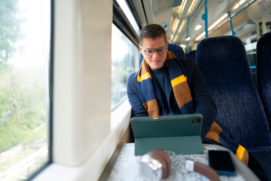 Business Traveler Working On Tablet In Train
