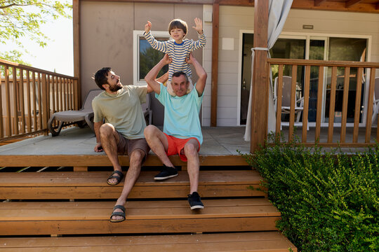 Family relaxing on wooden terrace