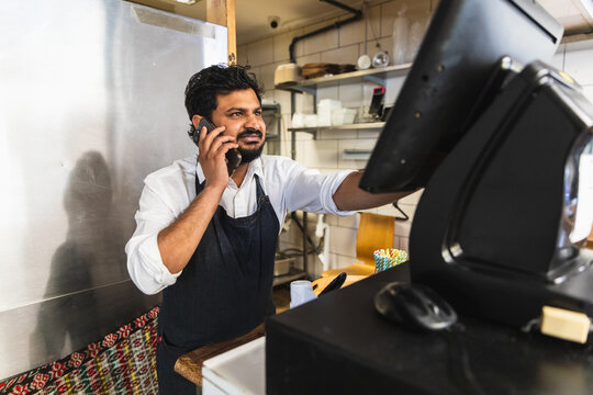 Indian restaurant worker taking phone order