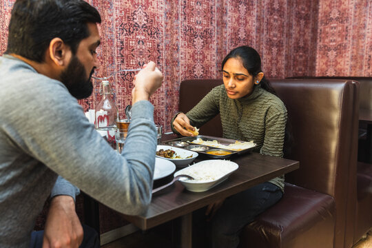 Couple enjoying authentic Indian meal at restaurant
