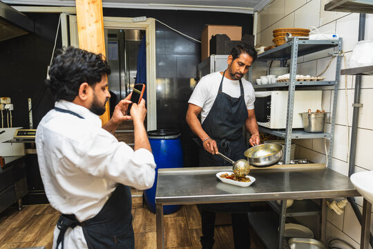 Indian chef taking food photo for social media