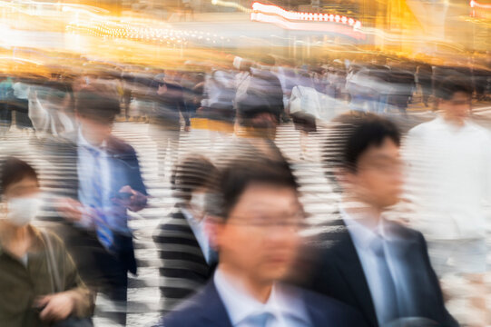 Blurred Crowd Crossing Busy City Street