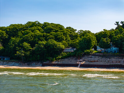  Aerial view of Lake Michigan shoreline with wooded bluffs and lakefront homes in Norton Shores, Muskegon, Michigan&rdquo;