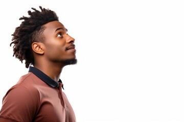 Obraz premium Young man with dreadlocks looking up, expressing hopeful future and curiosity