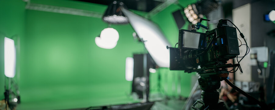 Professional cinema and video camera on the set. Shooting shift, lighting fixtures, shooting equipment and the team. Technique of modern filming and advertising.