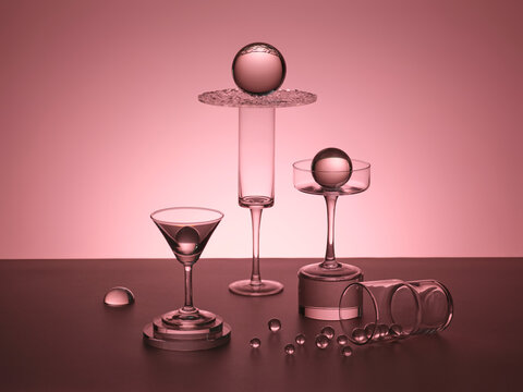 Elegant glass spheres balanced on delicate glassware on gradient pink