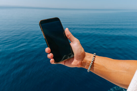 Man taking a photo of the sea scene 