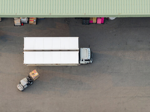 Aerial Logistics Truck and Forklift at Warehouse