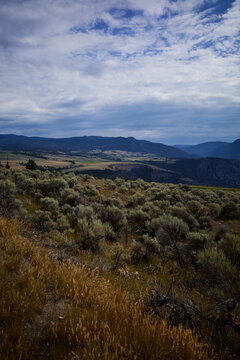 Vast landscape with fields and mountains on a cloudy day