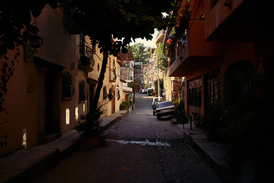 Quiet street with buildings and parked car in Mexico during the day