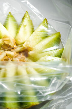 Close View of Cut Fruit Wrapped in Plastic in a Kitchen
