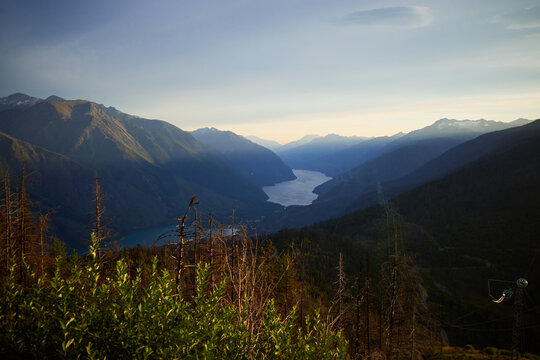 Mountains surround a winding river at sunset in a valley